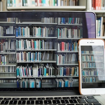 Photo of bookshelves on the screens of a laptop and a smartphone